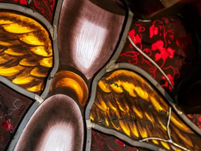 Stained glass image of an hourglass with wings