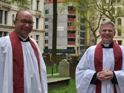 Phil Jackson and Michael Bird welcome parishioners back to Trinity Church.