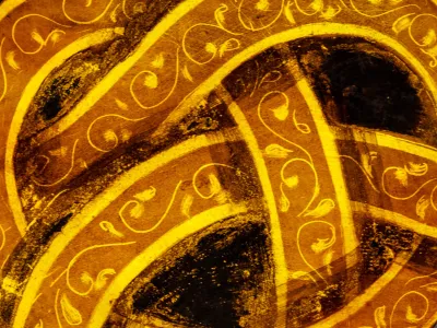 A close-up of a stained glass window depicting a golden knot