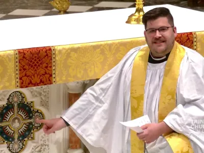 Father Matt kneeling by the altar.