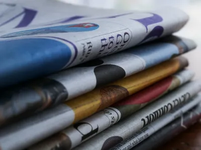 A close up of a stack of newspapers