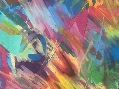 A rainbow of oil pastel strokes layered over each other