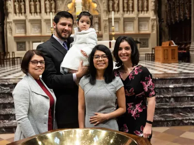 A family poses in Trinity Church on All Saints Sunday 2021