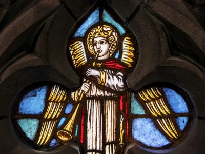 A stained glass window depicting an angel with a trumpet in the Chapel of All Saints in Trinity Church