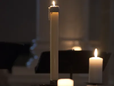 Candles glow in the darkness in St. Paul's Chapel