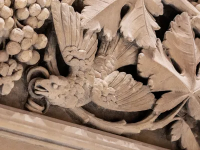 Detail photo of plaster work depicting a bird and foliage in Trinity Church