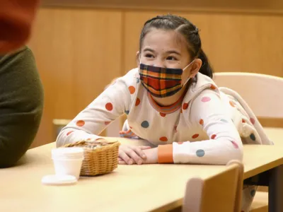 A child smiles during Children’s Time at Trinity Commons