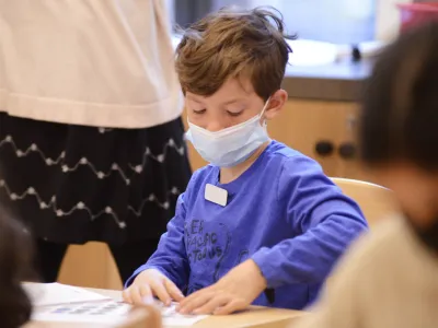 A child working on an activity sheet during Children’s Time