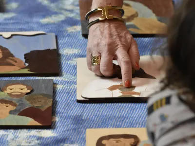 An adult hand pointing to drawings of people from the Bible during Children’s Time