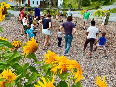 Families playing in a sunflower garden