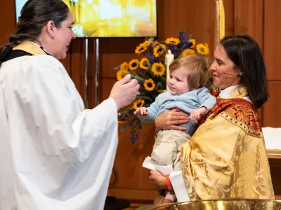 The Rev. Elizabeth Blunt and the Rev. Kristin Kaulbach Miles with a baptism