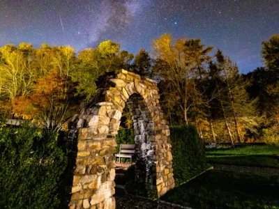 Stone arch under a brilliant night sky