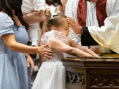 A child is baptized in Trinity Church on Pentecost Day