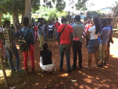 Residents of the coastal town Pestel meet under a tree to discuss the impact of the recent earthquake on their community’s livelihood.