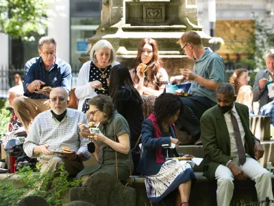 A group of parishioners enjoy lunch on the steps of the Soldiers' Monument in the northeast corner of Trinity Churchyard during a Spring 2022 Celebration.