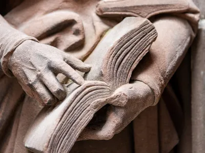 Statue holding a book