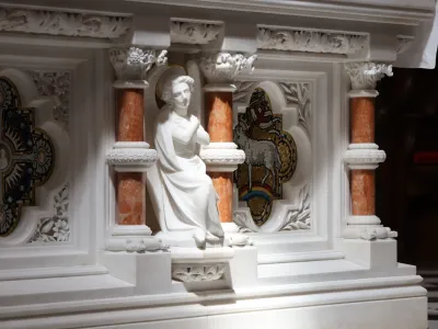 Light shines on the carving of a figure on the altar of Trinity Church