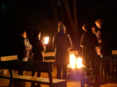 Retreatants gathered around a campfire