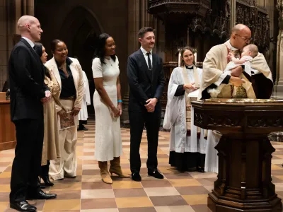 The Rev. Phil Jackson performs a baptism on All Saints' Sunday