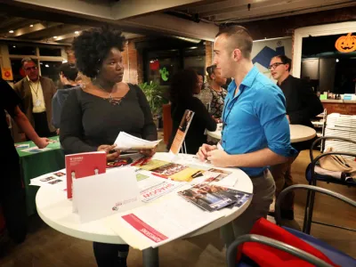 Two people stand at a table