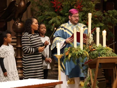 A family lights the Advent wreath during the 9am service in Trinity Church