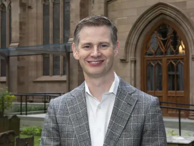 Neill Coleman stands in front of Trinity Church