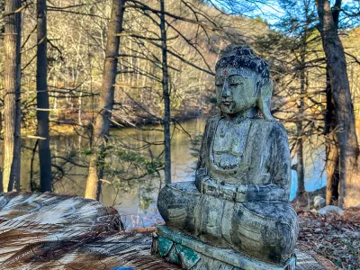 Buddha statue by lake