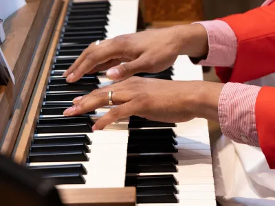 A musician's hands on the organ keyboard in Trinity Church