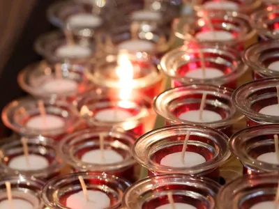 One prayer candle burning among others in Trinity Church