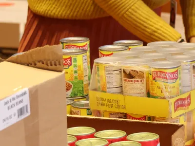 Image of volunteer packaging cans of food