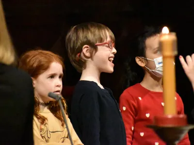 A smiling and singing child during the 9am service at Trinity Church