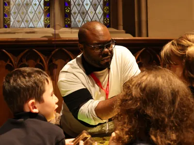 Wayne Edwards works with children at the Blessing of the Animals, 2022