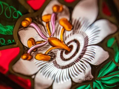 A white flower depicted in a stained-glass window at Trinity Church