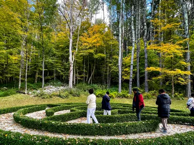 People walk in the hedge maze at the Trinity Retreat Center
