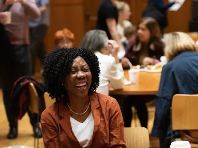 A woman is laughing at a class