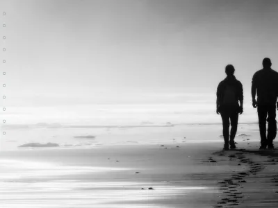 "Being With" two people walk together along a misty beach