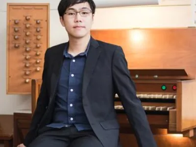 Theodore Cheng sitting at an organ.