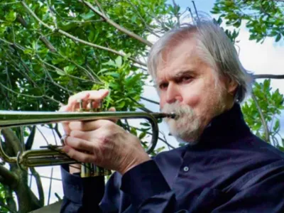 Tom Harrell with trumpet in a park.