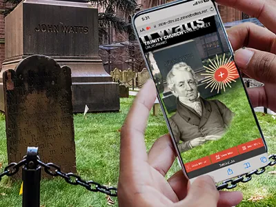 Hands holding a phone with the AR app showing in the Trinity Churchyard