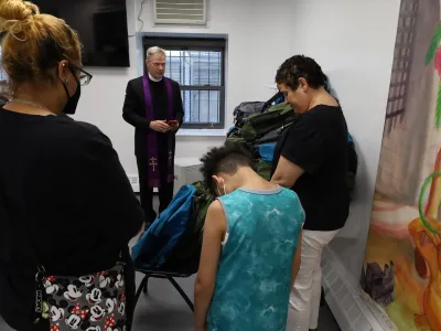 The Rev. Michael Bird blesses backpacks at The Loisaida Center on September 6, 2023