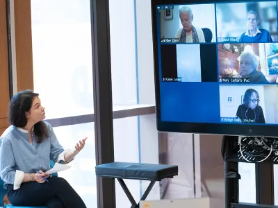 Summerlee Staten addresses Zoom presenters and attendees at a hybrid Discovery event