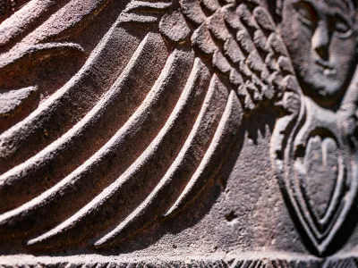 Detail of a headstone in Trinity Churchyard featuring the head and wings of an angel