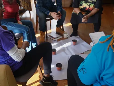 Who Keeps the Keeper program participants sit in a circle in group discussion at the Trinity Retreat Center.