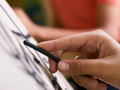 Close-up photo of a hand drawing with charcoal