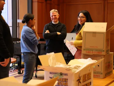The Vicar and Trinity Outreach staff pack groceries at the Christmas Compassion Market pack.