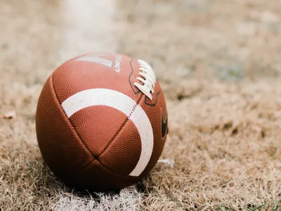 A football on a grass field. 