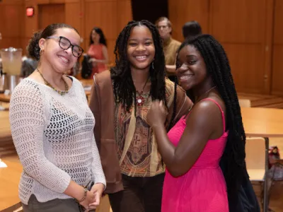 Three Trinity Youth members hang out in the parish hall. 