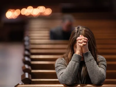 A parishioner bows in prayer in Trinity Church