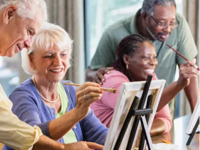 A pair of senior couples paint.