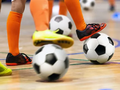 Close up shot of people playing with soccer balls.